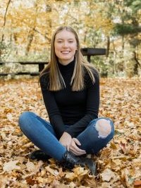 Grace Beebe sitting in a forest